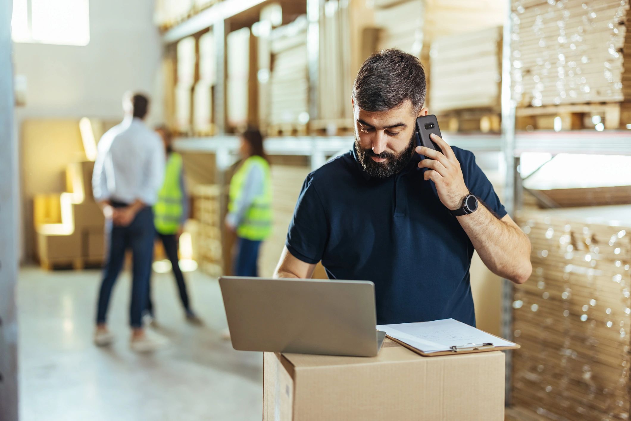 Warehouse team using a laptop to manage inventory